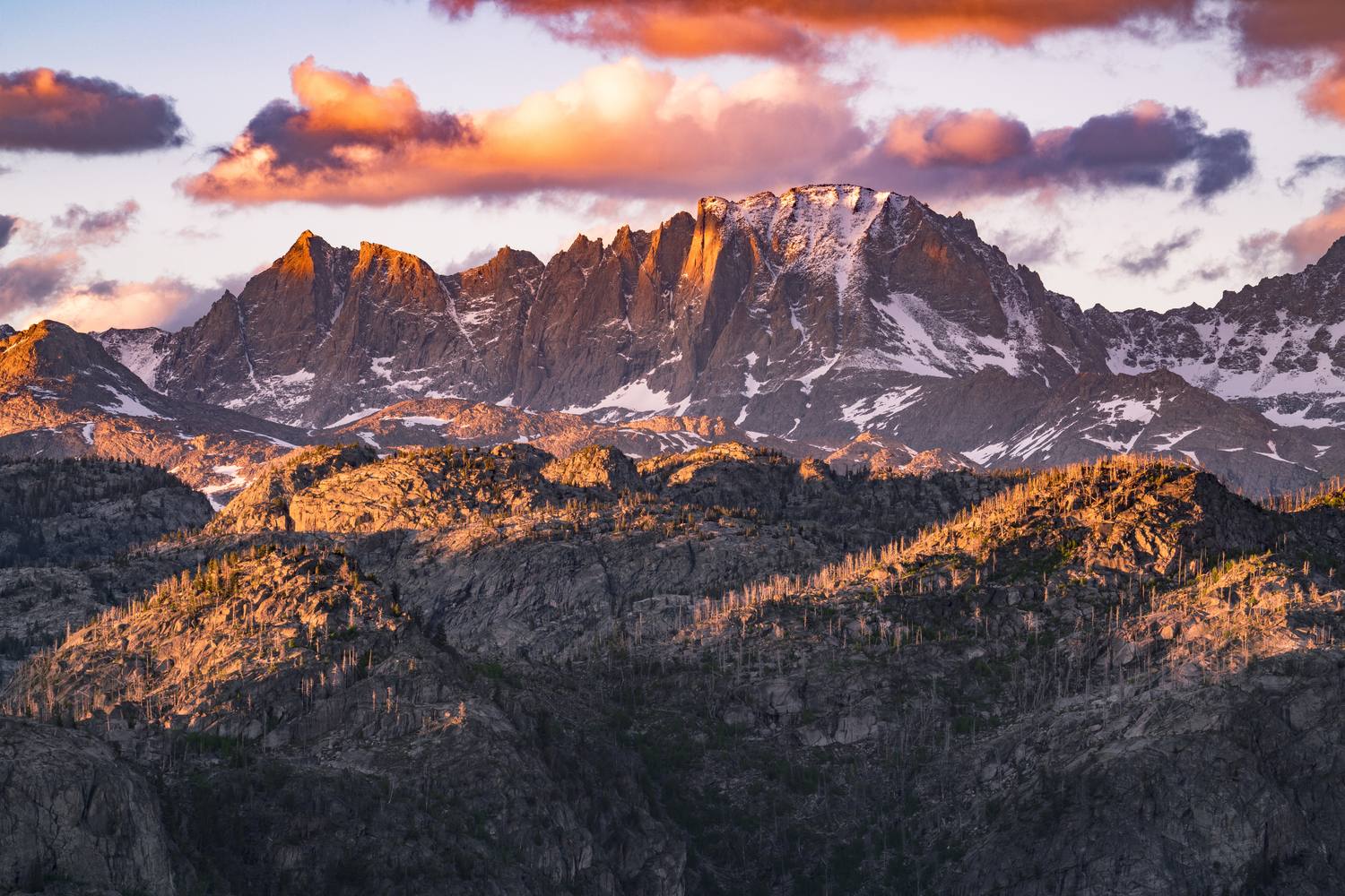 Alpenglow on the granite walls of Mount Sacagawea and Fremont Peak in the Wind River Range.